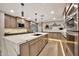 Modern kitchen features stainless appliances, center island with quartz countertops, and ample storage at 1955 E Greenway Rd, Phoenix, AZ 85022