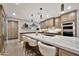 Bright kitchen featuring a large island with seating, custom cabinets, and stainless steel appliances at 1955 E Greenway Rd, Phoenix, AZ 85022