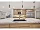 Stunning kitchen island with a black sink, designer faucet, and marble countertop, ideal for meal prep and casual dining at 1955 E Greenway Rd, Phoenix, AZ 85022