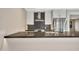 Stylish kitchen featuring a dark countertop island, stainless steel appliances, and modern white cabinetry at 1955 E Greenway Rd, Phoenix, AZ 85022