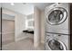 Convenient laundry area with stacked washer/dryer and modern sink with bright vanity mirror at 1955 E Greenway Rd, Phoenix, AZ 85022