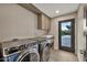 Convenient laundry room with modern appliances and an exterior entrance at 1955 E Greenway Rd, Phoenix, AZ 85022
