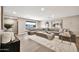 Spacious living room featuring a large sectional sofa, modern decor, and recessed lighting at 1955 E Greenway Rd, Phoenix, AZ 85022