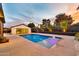 Backyard pool with fountain features, modern patio, and landscaped privacy wall at 1955 E Greenway Rd, Phoenix, AZ 85022
