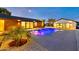 Beautiful backyard pool featuring a modern design, water features, and desert landscaping at 1955 E Greenway Rd, Phoenix, AZ 85022