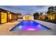 Stunning backyard pool featuring a modern design, water features, and desert landscaping at 1955 E Greenway Rd, Phoenix, AZ 85022