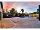 Backyard pool with fountain features, modern patio, and landscaping in a desert setting at 1955 E Greenway Rd, Phoenix, AZ 85022