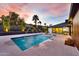 Backyard pool area with water features, modern patio, and carefully landscaped garden beds at 1955 E Greenway Rd, Phoenix, AZ 85022