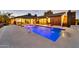 A stunning pool with integrated fountains is surrounded by modern patio and architectural lighting at 1955 E Greenway Rd, Phoenix, AZ 85022