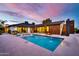 Backyard pool with fountain features, framed by the home's modern architectural design at 1955 E Greenway Rd, Phoenix, AZ 85022