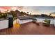 Inviting rooftop deck features two chairs, a table, and stunning views of the nearby mountain at sunset at 1955 E Greenway Rd, Phoenix, AZ 85022