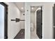 Modern shower room with dark accent tiles, stylish shower fixtures, and an adjoining toilet room at 1955 E Greenway Rd, Phoenix, AZ 85022