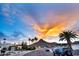 Scenic street view showcases a vibrant sunset sky with palm trees and a glimpse of a neighborhood street at 1955 E Greenway Rd, Phoenix, AZ 85022
