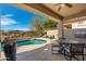 Covered patio with a view of a private pool and lush desert landscaping perfect for outdoor living at 20378 N 96Th Way, Scottsdale, AZ 85255