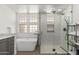 Bright bathroom with frameless glass shower, soaking tub, and modern fixtures, offering a spa-like experience at 20378 N 96Th Way, Scottsdale, AZ 85255