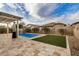 Relaxing backyard with a sparkling pool, lush lawn, and privacy fence at 20552 E Reins Rd, Queen Creek, AZ 85142