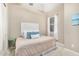 Cozy bedroom with neutral walls, carpet flooring, a full-size bed, and a window with sheer curtains at 20552 E Reins Rd, Queen Creek, AZ 85142