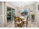 Bright dining room with wood flooring, a modern chandelier, and sliding glass doors to the patio at 20552 E Reins Rd, Queen Creek, AZ 85142
