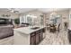 Modern kitchen featuring an island with granite countertops and a sink, open to the living and dining area at 20552 E Reins Rd, Queen Creek, AZ 85142