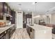 Modern kitchen with granite countertops, stainless steel appliances, and center island with bar seating at 20552 E Reins Rd, Queen Creek, AZ 85142