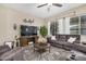 Comfortable living room with plush furniture, decorative rug, and natural light from large windows at 20552 E Reins Rd, Queen Creek, AZ 85142