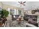 Comfortable living room with plush furniture, decorative rug, and natural light from large windows at 20552 E Reins Rd, Queen Creek, AZ 85142