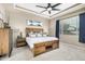 Spacious bedroom features tray ceilings, a ceiling fan, and warm natural lighting at 20552 E Reins Rd, Queen Creek, AZ 85142