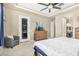 Spacious main bedroom featuring a ceiling fan, dresser, sitting chair, and a door leading to the outside at 20552 E Reins Rd, Queen Creek, AZ 85142