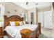 Spacious main bedroom with a luxurious wood bed frame, ensuite bathroom, and neutral decor at 20552 E Reins Rd, Queen Creek, AZ 85142