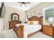 Bright main bedroom features a decorative wood frame bed, plush carpet, and matching dresser set at 20552 E Reins Rd, Queen Creek, AZ 85142