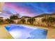 Backyard pool, spa, and desert landscaping create an outdoor retreat at 20552 E Reins Rd, Queen Creek, AZ 85142