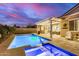 Inviting backyard pool with jacuzzi, covered patio, and professional landscaping at 20552 E Reins Rd, Queen Creek, AZ 85142