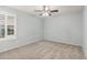 Neutral bedroom with a ceiling fan, carpeted floors and plantation shutters on the window at 21216 N 96Th Ave, Peoria, AZ 85382