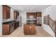 A spacious kitchen featuring dark wood cabinets, granite countertops, and stainless steel appliances at 21216 N 96Th Ave, Peoria, AZ 85382