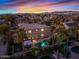 An elevated twilight view of a home reveals a backyard oasis with a pool, gazebo, and professional landscaping at 21503 E Alyssa Ct, Queen Creek, AZ 85142
