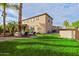 A spacious backyard features well-manicured lawn, palm trees, swimming pool, gazebo, and lounge chairs at 21503 E Alyssa Ct, Queen Creek, AZ 85142