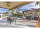 Enjoy the beautiful backyard pool with palms, waterfall feature, outdoor seating, and covered patio with ceiling fan at 21503 E Alyssa Ct, Queen Creek, AZ 85142