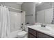 Clean bathroom with shower-tub combo, white tiled walls, and a dark vanity at 21503 E Alyssa Ct, Queen Creek, AZ 85142