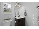 Cozy half bathroom with a dark wood vanity cabinet, granite countertop, and accent mirror at 21503 E Alyssa Ct, Queen Creek, AZ 85142