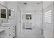 Elegant bathroom featuring double sinks, white marble, and a glass-enclosed shower at 21503 E Alyssa Ct, Queen Creek, AZ 85142