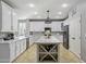 Bright kitchen with large island features quartz countertops, stainless steel appliances, and sleek white cabinets at 21503 E Alyssa Ct, Queen Creek, AZ 85142