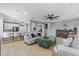 Bright open living room flows to kitchen with modern finishes, tile flooring, and decorative furniture at 21503 E Alyssa Ct, Queen Creek, AZ 85142
