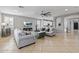 Spacious living room with cozy furniture, modern fixtures, and seamless flow to the kitchen and dining area at 21503 E Alyssa Ct, Queen Creek, AZ 85142