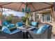 Cozy backyard seating area under a gazebo with a fire pit and comfortable seating with blue cushions at 21503 E Alyssa Ct, Queen Creek, AZ 85142