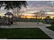 Community playground with slides and swings set against a colorful sunset, perfect for Gathering fun at 21503 E Alyssa Ct, Queen Creek, AZ 85142