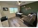 Bedroom with stylish flooring, neutral walls, and a window overlooking a green outdoor space at 22803 S 215 St, Queen Creek, AZ 85142