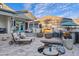 Well-maintained backyard with stone pavers, pool with waterfall feature and outdoor fireplace at 2643 E Tamarisk St, Gilbert, AZ 85296
