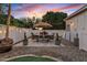 Inviting backyard featuring a dining table with umbrella, gravel landscaping, and privacy fence at 2643 E Tamarisk St, Gilbert, AZ 85296