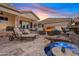 Relaxing backyard features a tranquil pool and spa, a cozy fireplace, and comfortable lounging and dining spaces at 2643 E Tamarisk St, Gilbert, AZ 85296