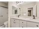 Bathroom with double sinks, white cabinetry, quartz countertops, and modern fixtures at 2643 E Tamarisk St, Gilbert, AZ 85296